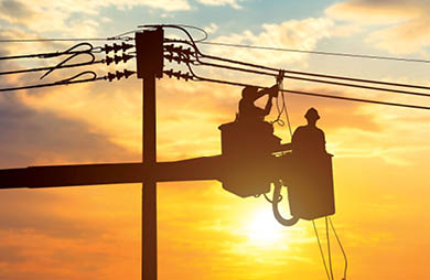 Silhouette electrician work at height on crane to make electrical connections. High voltage electrical system.