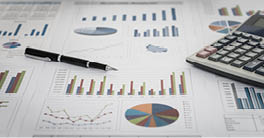 financial graph and chart report with pen, calculator on desk of financial advisor.