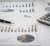 financial graph and chart report with pen, calculator on desk of financial advisor.